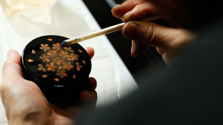 TOKYO, JAPAN - AUGUST 23: Lacquer artist and Japanese living national treasure Kazumi Murose paints on a lacquerware at the Mejiro Institute of Urushi Conservation on August 23, 2016 in Tokyo, Japan. Isetan Mitsukoshi Holdings
