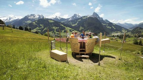 Gstaad's Fondue Land trail involves hiking to a mountain top and eating fondue in a fondue pot-shaped table.