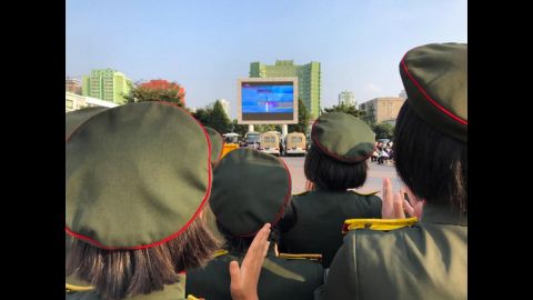 The crowd applauds as North Korean TV airs footage of their latest missile launch outside Pyongyang Station on August 30, 2017.