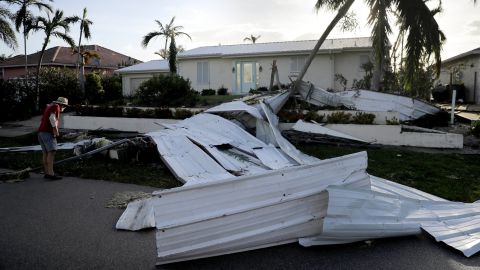 Rick Freedman checks his neighbor's damage from Hurricane Irma on Marco Island, Florida.