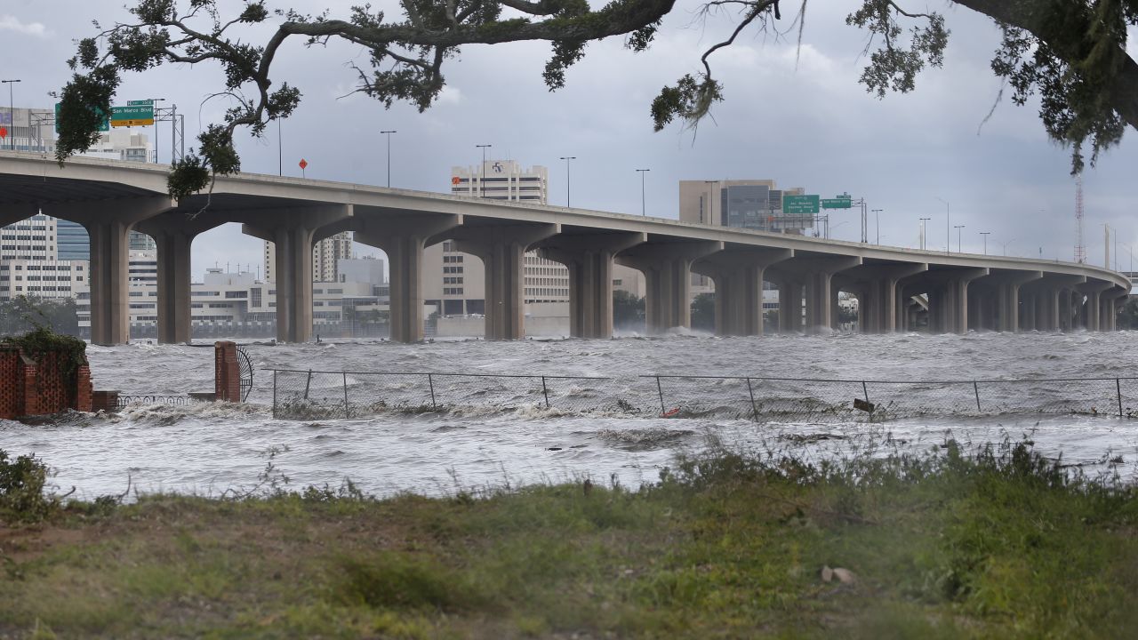 Waves on the St. Johns River crash against a bridge in Jacksonville.