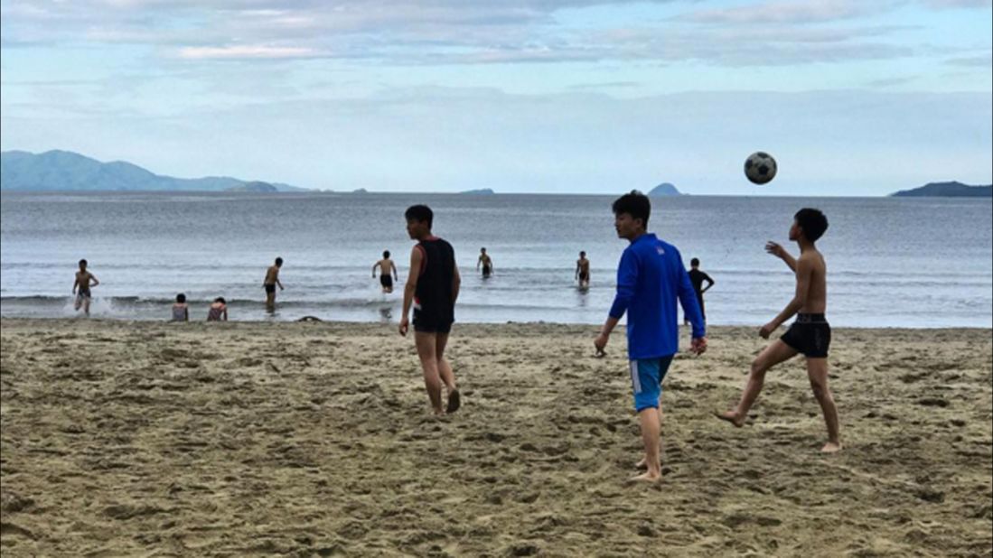 North Korean high school students play on a beach at Wonsan, on September 11, 2017.