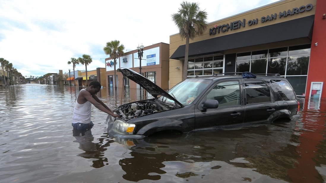 John Duke tries to salvage his flooded vehicle in Jacksonville on September 11.
