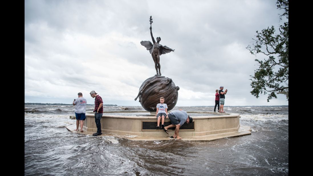 People check out floodwaters at Jacksonville's Memorial Park on September 11.