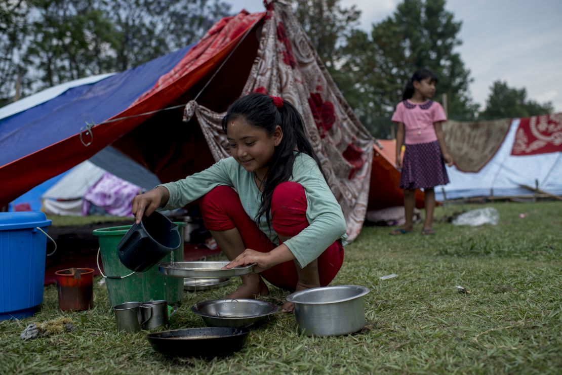 A young girl shelters on the greens of the Royal Nepal Golf Club following the earthquake that devastated Kathmandu in 2015.