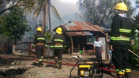 Firefighters attempt to extinguish fires in the the Maungdaw township in Rakhine State, August 27, 2017.