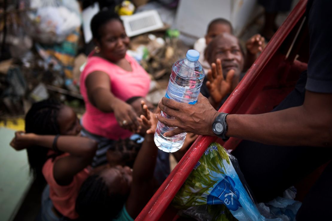 French firemen provide bottles of water to residents of Marigot, St. Martin, on September 10.