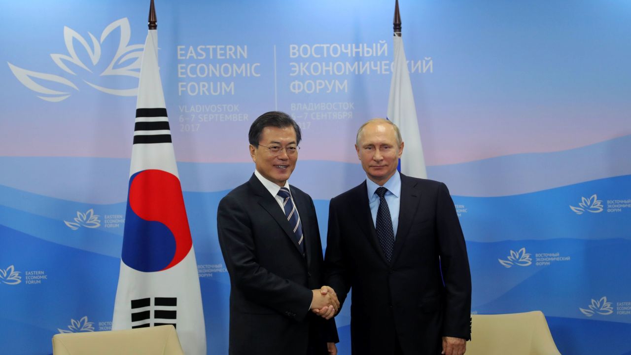 Russian President Vladimir Putin (R) shakes hands with South Korea's Moon Jae-in in Vladivostok on September 6, 2017.