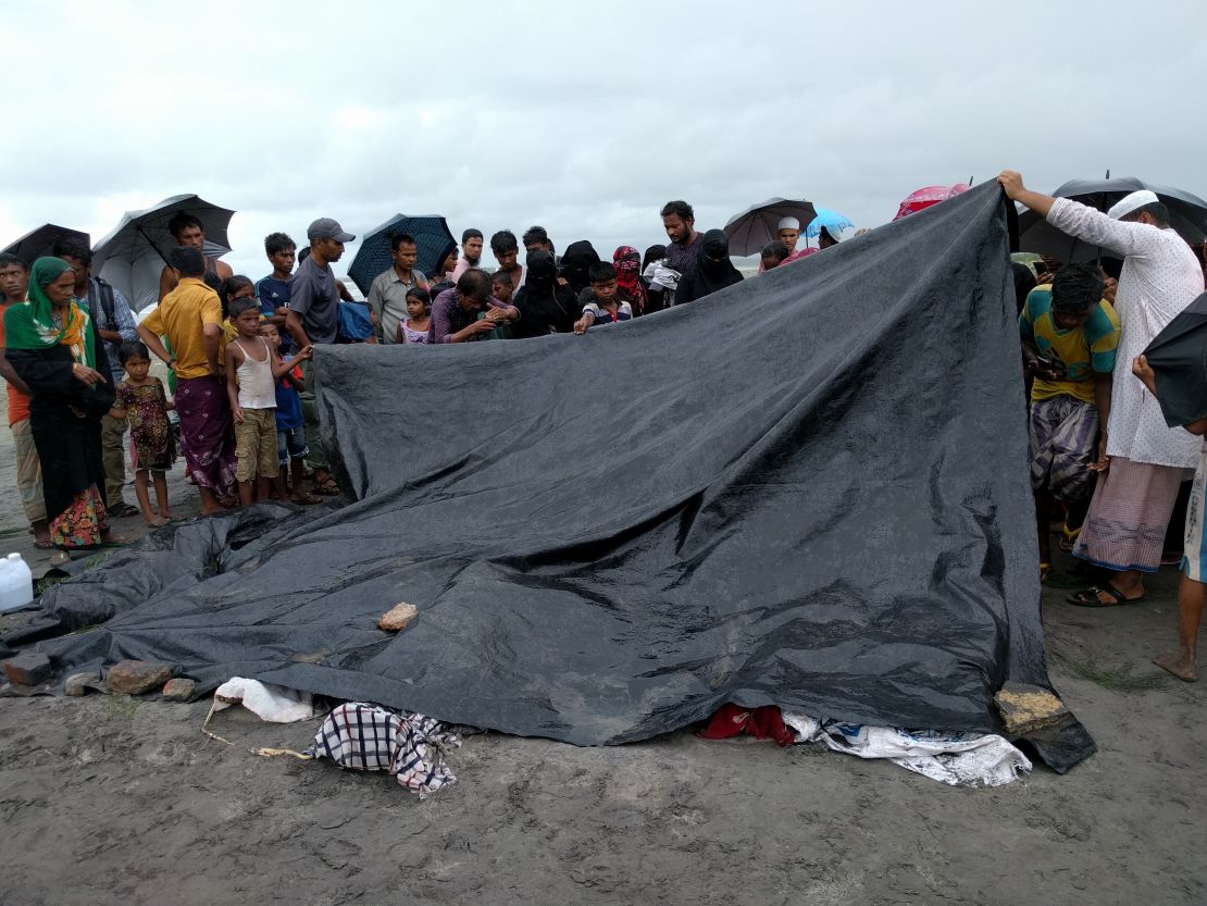 People gather near the dead bodies of 10 Rohingya children who had killed after a boat carrying Rohingya people capsized off Bangladesh's southeastern coast, in Teknaf, Bangladesh on August 31, 2017. 