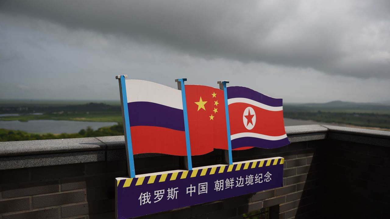 This photo taken on June 25, 2015 shows the flags of Russia (L), China (C) and North Korea (R) on a viewing tower on the border between the three countries in Hunchun, China's northeast Jilin province.
