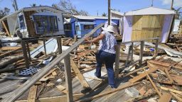 Mirta Mendez walks through the debris at the Seabreeze trailer park along the Overseas Highway in the Florida Keys on Tuesday, Sept. 12, 2017. Florida is cleaning up and embarking on rebuilding from Hurricane Irma, one of the most destructive hurricanes in its history. (Al Diaz/Miami Herald via AP)