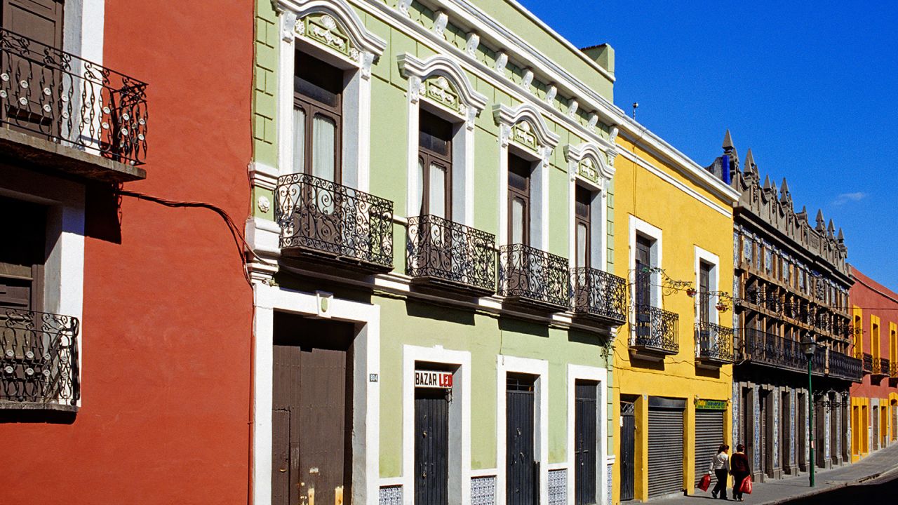 The narrow streets of central Puebla are lined with colorful row houses.