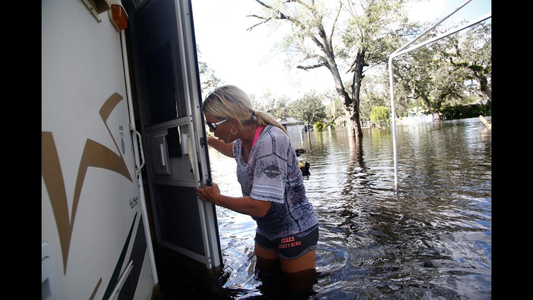 Waist-deep in floodwater, Shelly Hughes gets her first look at the inside of her camper in Arcadia, Florida, on September 12.