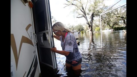 Shelly Hughes gets a first look at her flooded camper at a campground Tuesday in Arcadia, Florida.