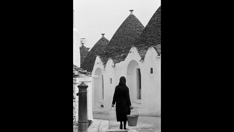 Known as trulli, these buildings with conical roofs abound in the town of Alberobello, in the southern part of Italy. They were built as early as the mid-14th century, using a mortarless technique. There are more than 1,600 of the structures in Alberobello, and they have been designated a UNESCO World Heritage site since 1996. Women in the town probably dress differently now from the one in her photo, but the buildings won't change. "They are a national treasure," says Wurmfeld. 