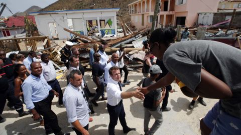 French President Emmanuel Macron shakes hands with residents during a visit to St. Martin on September 12.