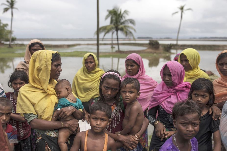 Refugees gather on the shoreline after arriving September 8, in Dakhinpara.