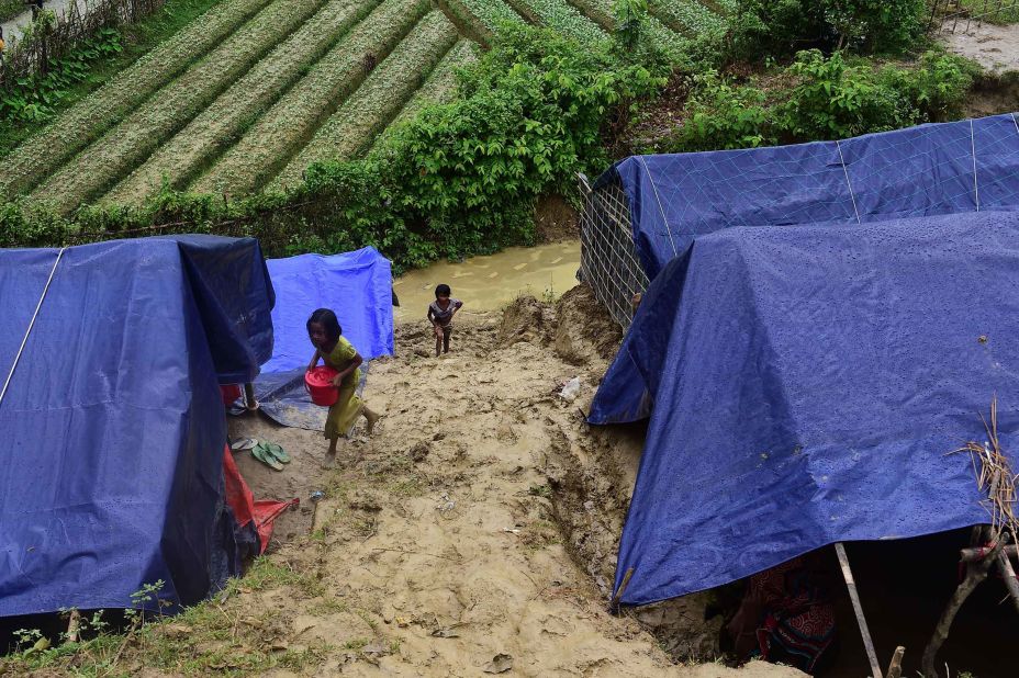 A Rohingya girl carries supplies on September 9, at a refugee camp in Ukhia, Bangladesh.