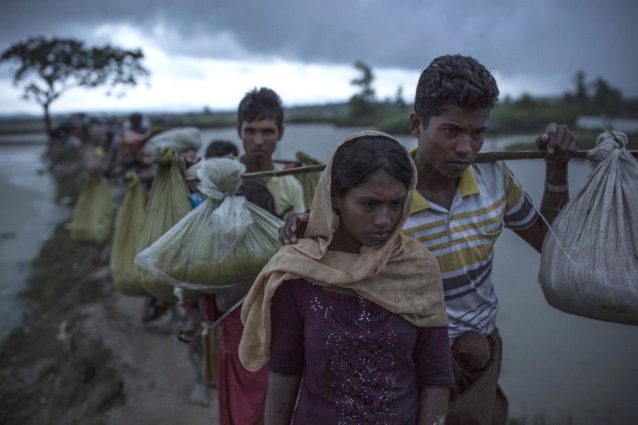 Rohingya refugees walk across paddy fields on September 9, after crossing the border in Gundum, Bangladesh.