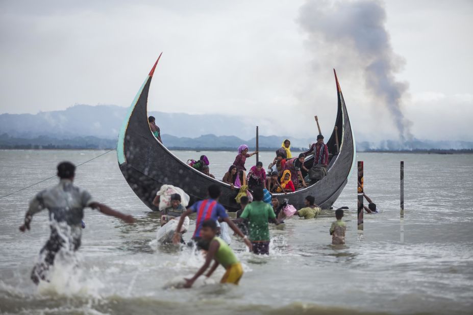 A boat full of Rohingya refugees arrives on September 9, on the Bangladeshi side of the Naf River.