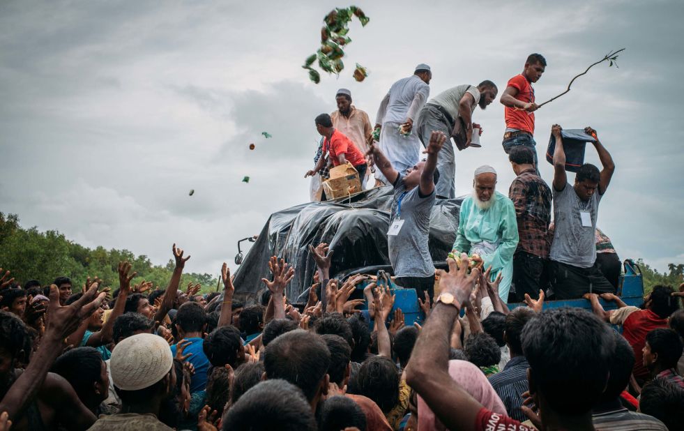 Bangladeshi volunteers distribute food on September 10, to Rohingya refugees in Chittagong, Bangladesh.