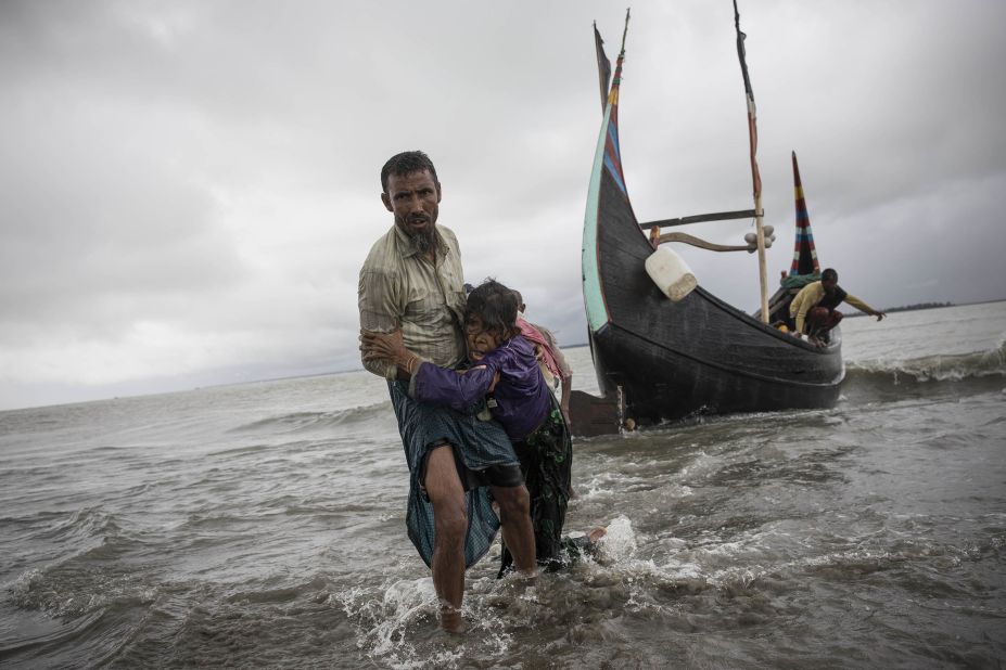 The woman is carried to shore after her boat crashed in Dakhinpara.