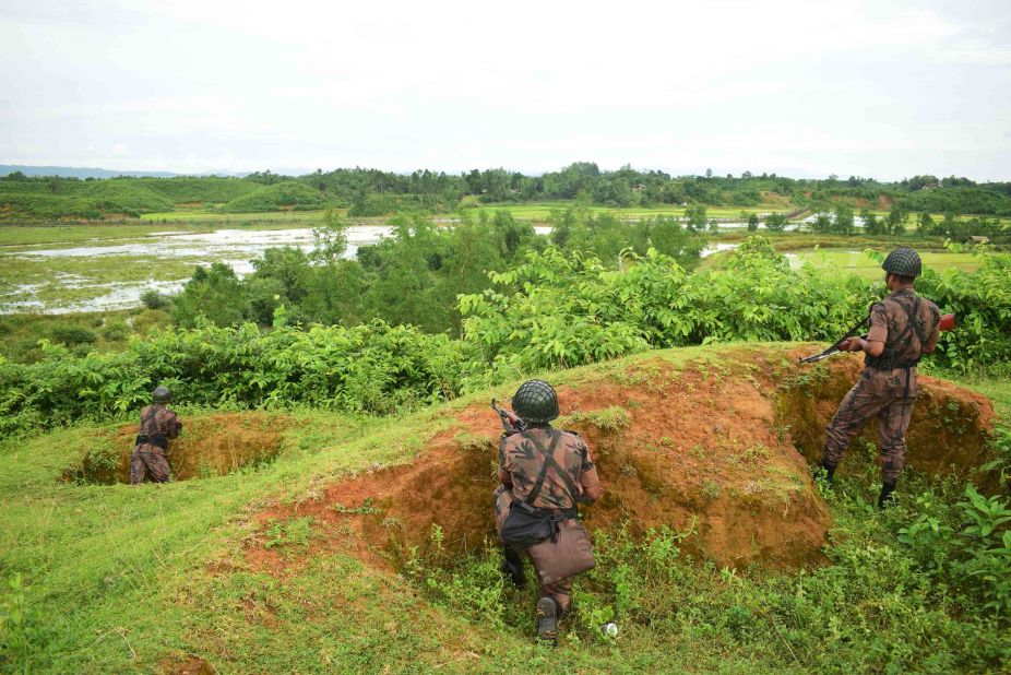 Bangladeshi border guards stand watch on August 26, as Rohingya refugees escape fresh gunfire near Myanmar's Rakhine state.