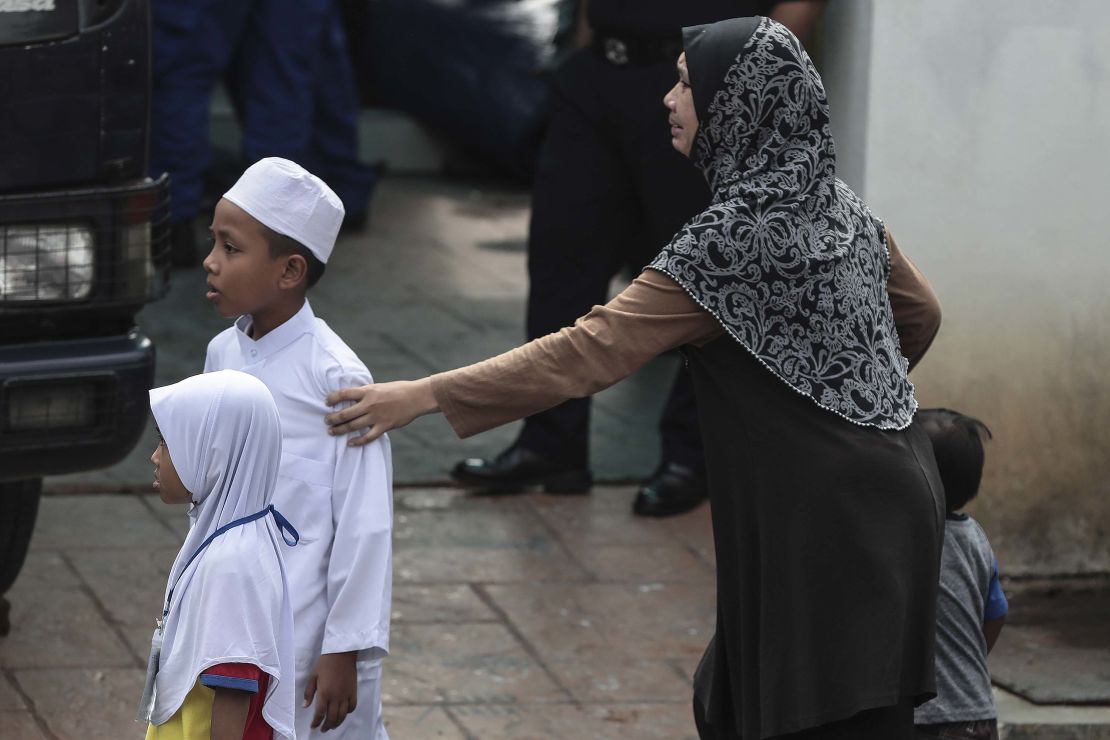 A relative of a teenage student cries after a fire broke out at a religious school in Kuala Lumpur, Malaysia, 14 September.