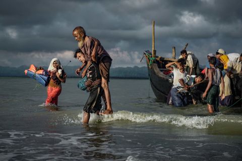 Rohingya refugees disembark from a boat on September 13 on the Bangladeshi side of the Naf River. 