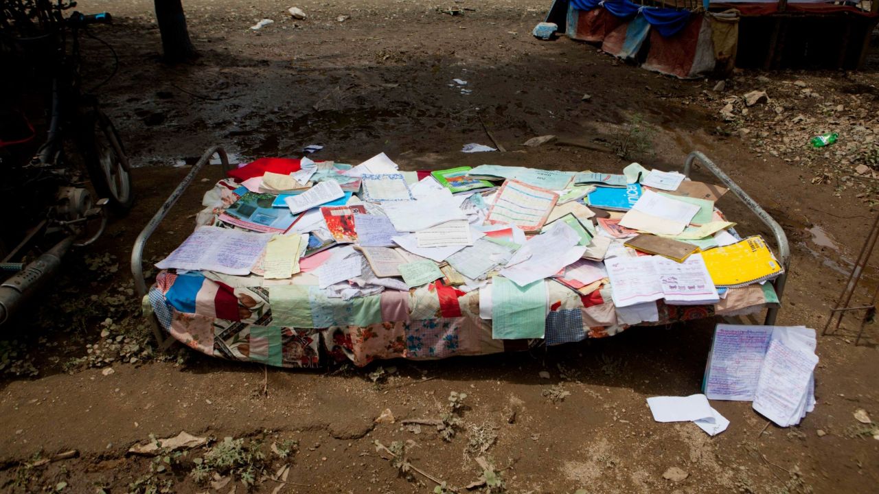 Personal papers and notebooks recovered from a flooded home are spread out on a cot in the aftermath of Hurricane Irma in Fort-Liberté, Haiti.