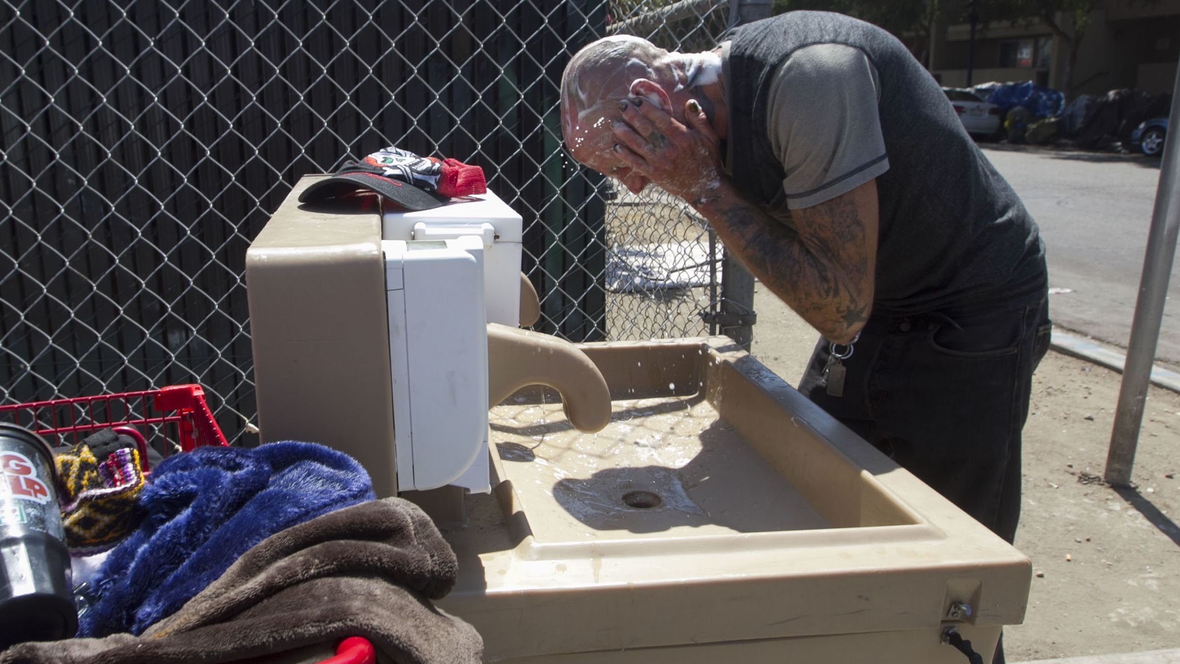 Jaime Lynn Hines cleans up at a hand-washing station installed by San Diego County.