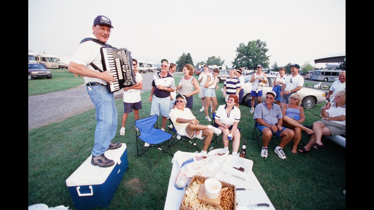 It's not just about food and drinks: music is also a key part of any tailgating party. Here, an accordion player entertains Penn State fans in 1999.