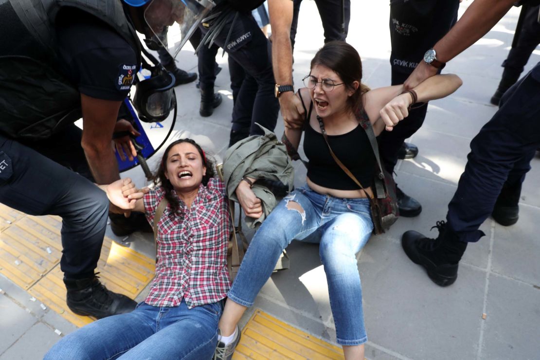 Riot police detain protesters outside a courthouse in Ankara on Thursday.