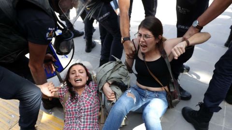 Riot police detain protesters outside a courthouse in Ankara on Thursday.