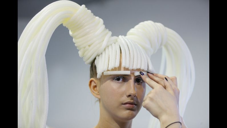 A model prepares backstage at a fashion show in Kiev, Ukraine, on Saturday, September 9.