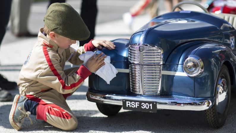 A boy wipes down a pedal car Saturday, September 9, at the <a href="https://petrolicious.com/articles/the-settrington-cup-is-where-the-kids-get-to-race-at-goodwood" target="_blank" target="_blank">Settrington Cup,</a> a children's race held annually at the Goodwood Revival festival in Chichester, England. 