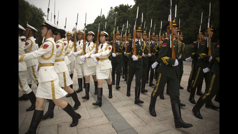 Chinese honor guard members march in formation Wednesday, September 13, before a welcoming ceremony for Brunei Sultan Hassanal Bolkiah.