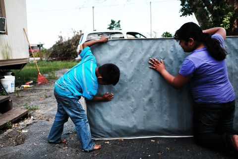 Children clean a dirty mattress from a flooded home in Immokalee, Florida, on Thursday, September 14. Hurricane Irma <a href="http://www.cnn.com/2017/09/07/americas/gallery/hurricane-irma-caribbean/index.html" target="_blank">laid waste to beautiful Caribbean islands</a> and caused historic destruction across Florida. The cleanup will take weeks; recovery will take months.