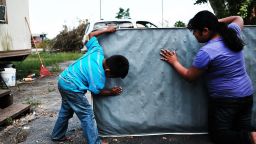 Children clean a dirty mattress from a flooded home in  Immokalee, Florida, on Thursday, September 14.