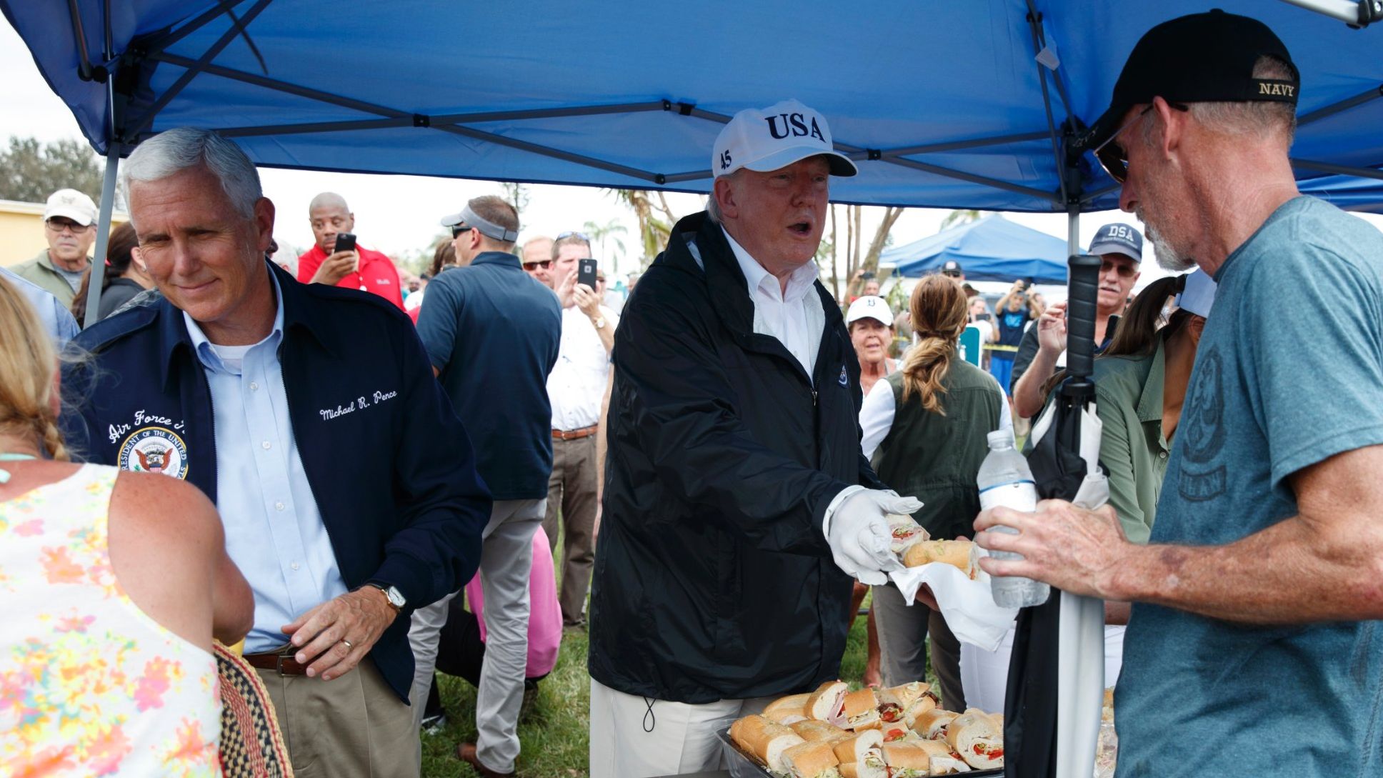 President Donald Trump and Vice President Mike Pence hand out food to people impacted by Hurricane Irma in Naples, Florida, on September 14.