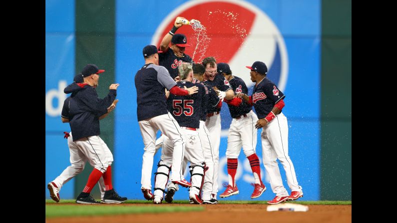 Teammates pile on Jay Bruce of the Cleveland Indians after his 10th-inning double defeated the Kansas City Royals on Thursday, September 14. The <a href="http://bleacherreport.com/articles/2733297-indians-extend-winning-streak-to-22-games-with-extra-innings-win-vs-royals" target="_blank" target="_blank">3-2 walk-off victory</a> extended the Tribe's winning streak to 22 games, just four short of the all-time major league record.