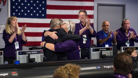 Cassini program manager Earl Maize, left, and spacecraft operations team manager for the Cassini mission at Saturn, Julie Webster, right, embrace after the Cassini spacecraft plunged into Saturn.