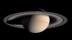 Saturn's pale colors and its rings come into view as Cassini approaches on May 7, 2004. This composite was made from images taken when Cassini was about 18 million miles (29 million kilometers) from Saturn. The small white dots are some of Saturn's moons.