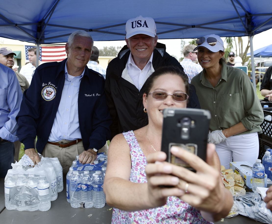 First lady Melania Trump poses for a selfie with her husband, President Trump, as they help serve food to people affected by Hurricane Irma, in Naples, Florida, on September 14, 2017. 