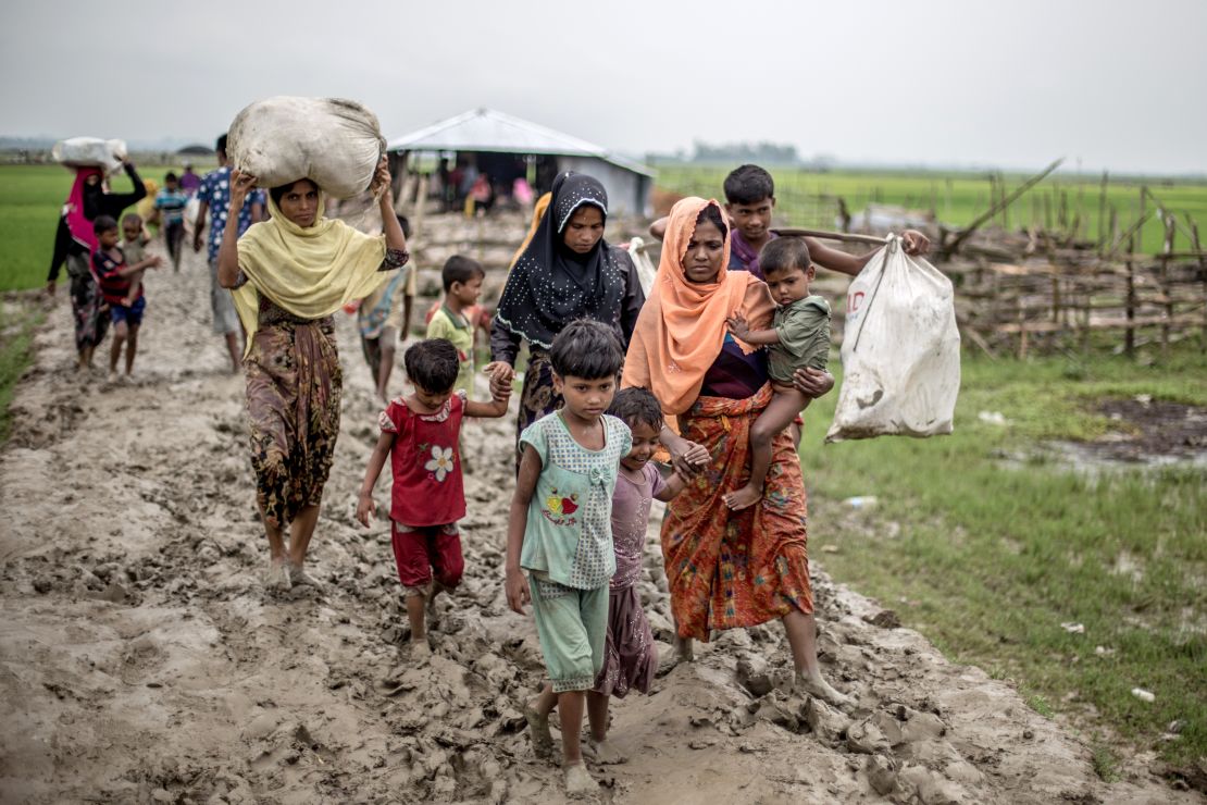 Rohingya familes arrive in Bangladesh, clutching what few possessions they can carry.