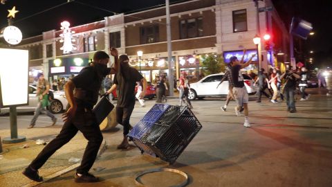 Protestors overturned trash cans and threw objects as police tried to disperse crowds.  
