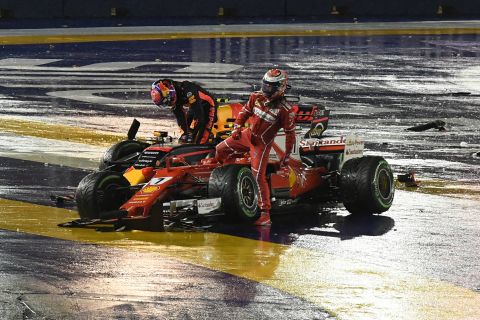 Kimi Raikkonen (right) and Max Verstappen step out of their cars after colliding at Sunday's Singapore Grand Prix 