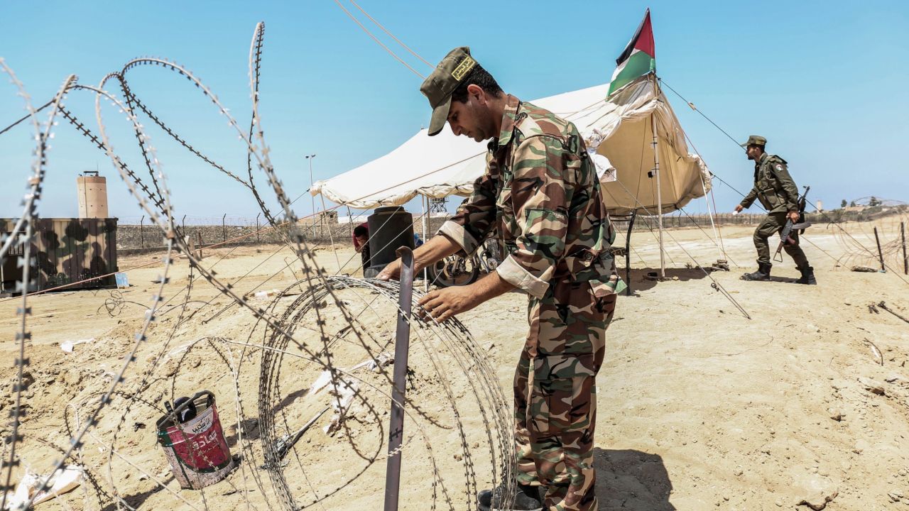 A member of the Palestinian security forces loyal to Hamas installs barbed wire along the border with Egypt near the southern Gaza town of Rafah in August.