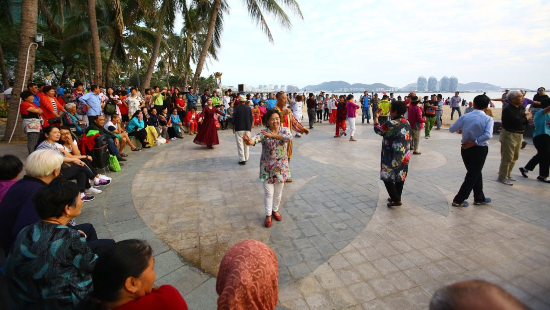 <strong>Daily dances: </strong>Every evening,<strong> </strong>almost as soon as the sun sets on Sanya in southern Hainan, dozens of locals begin to dance on the wide paved areas beneath the palm trees. 