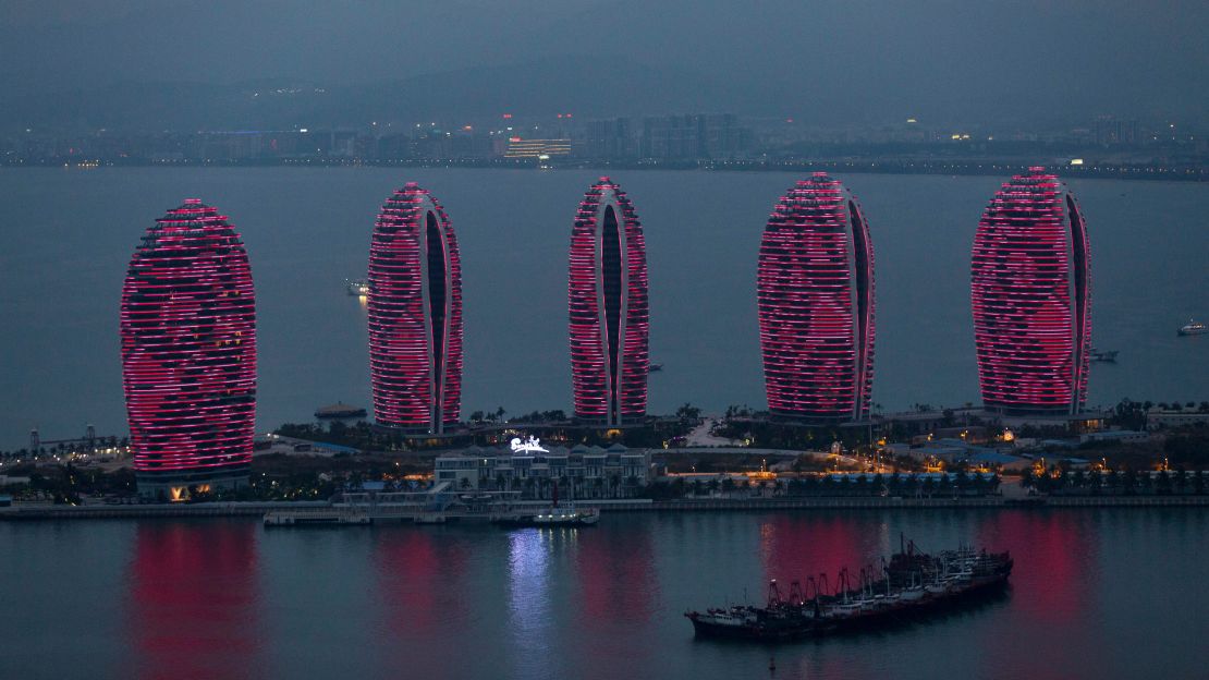 Buildings stand illuminated at night on Phoenix Island, a luxury resort in Sanya. 